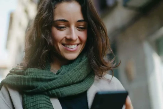 Woman scrolling her phone looking at cookieless advertising