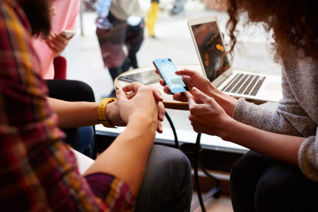 Travelers browsing hotels on a cell phone