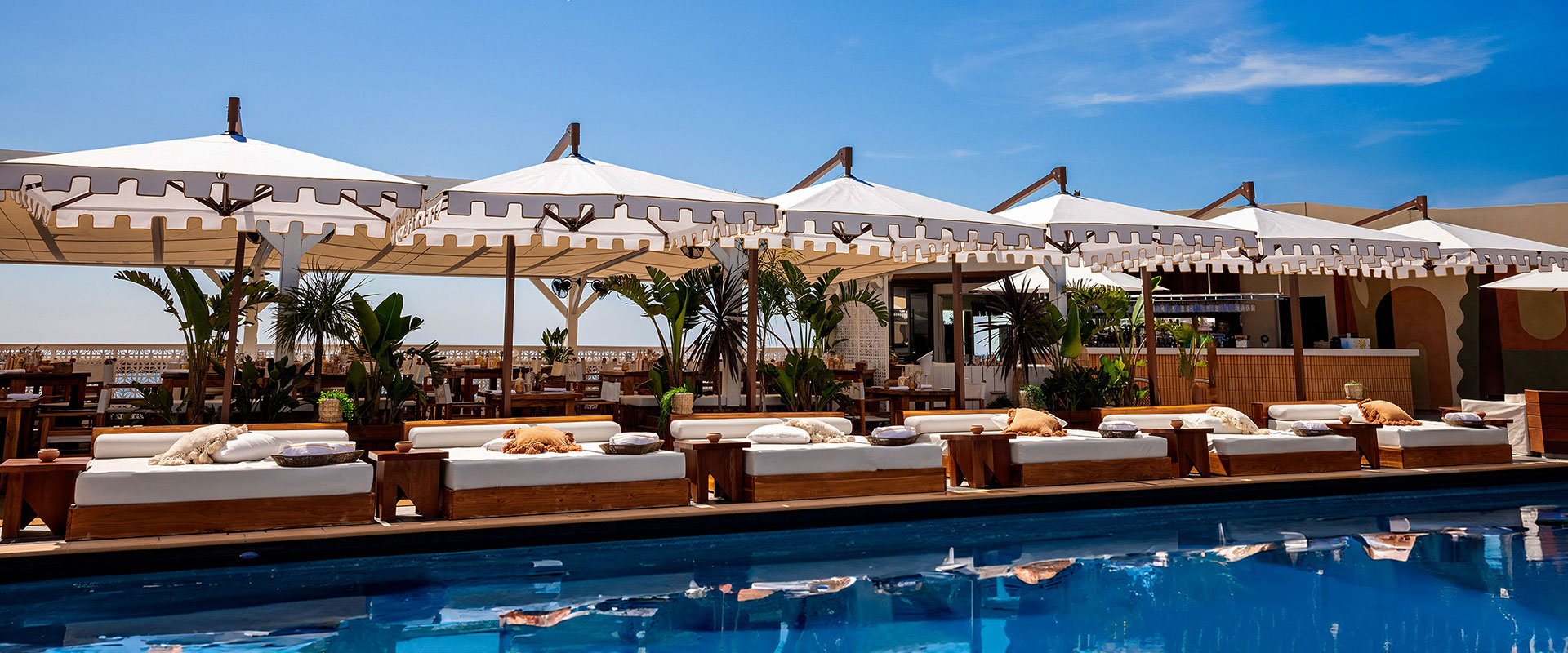 Fairmont Monaco resort pool lined by covered cabanas